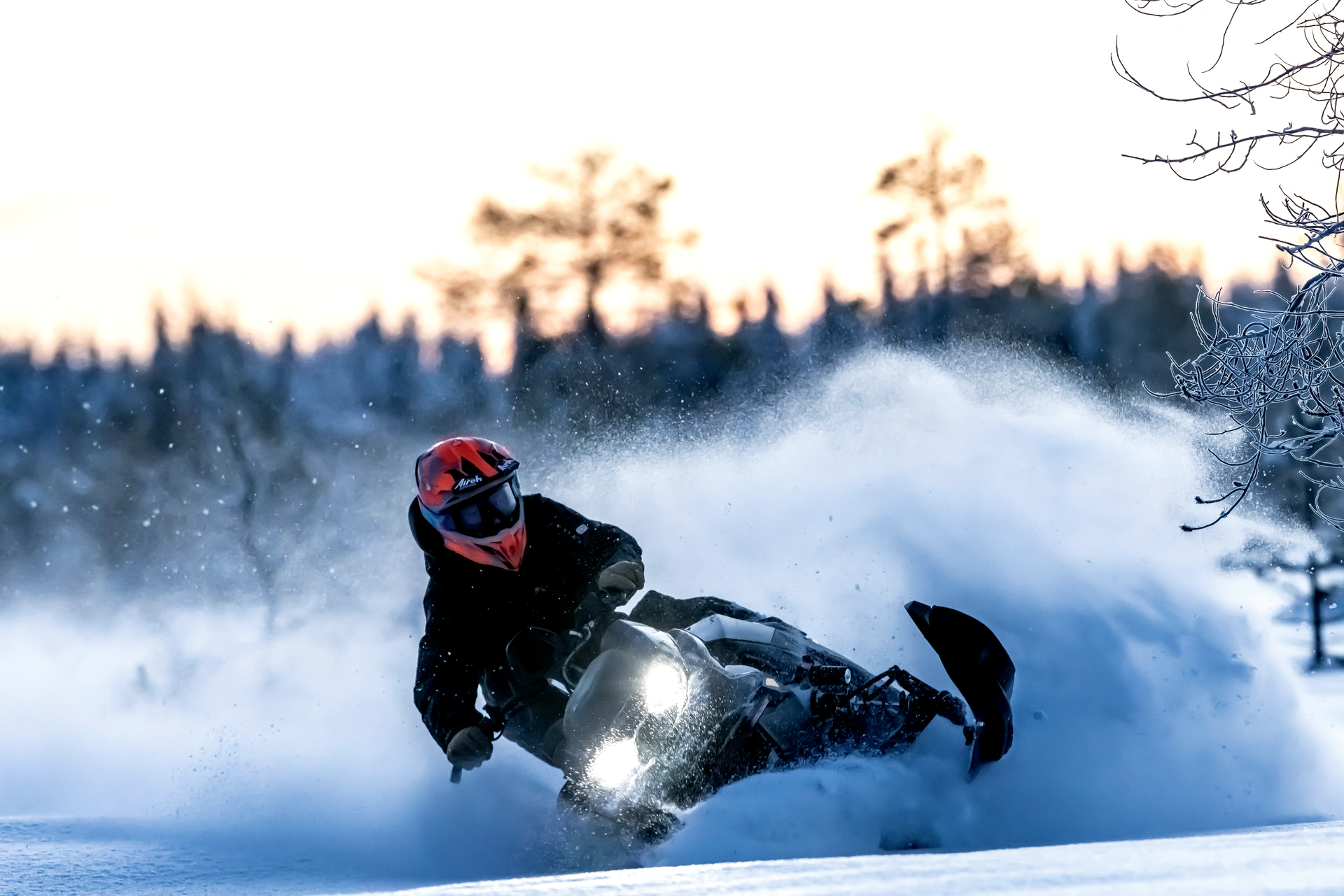 Snowmobile and rider in a winter landscape