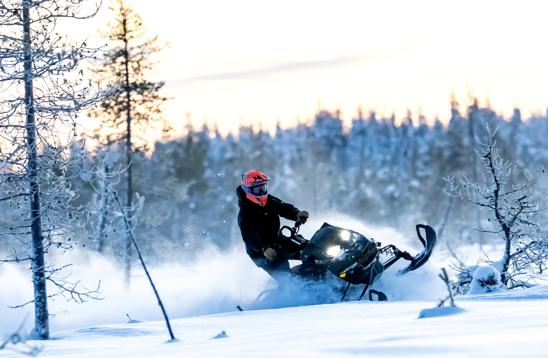 Snowmobile rider carving through deep powder